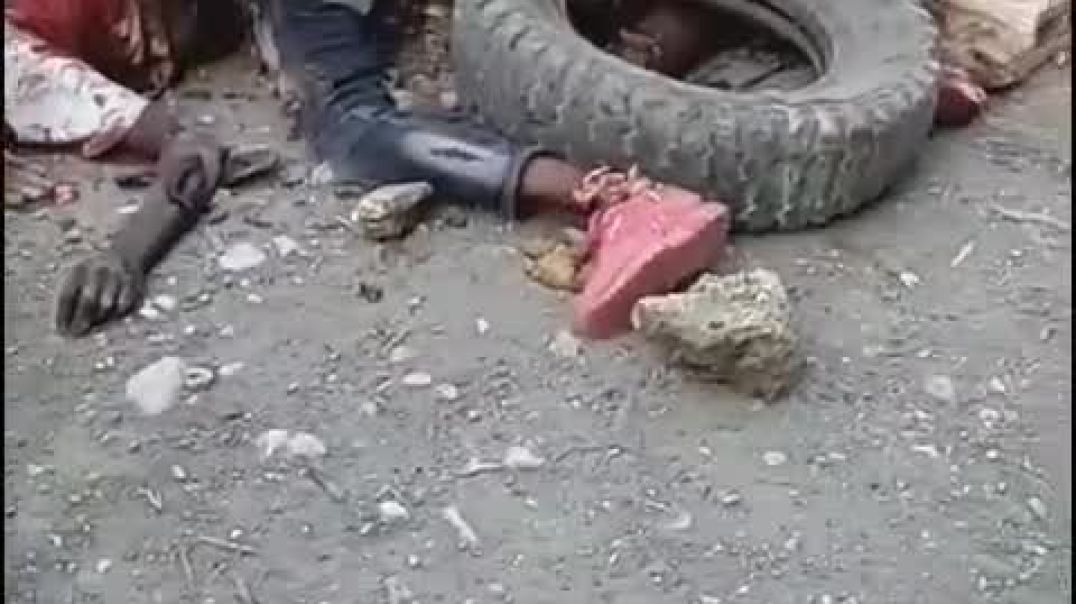 Upset crowd of Haitians caves in and crushes a guys skull and sets his body on fire. Haiti, February